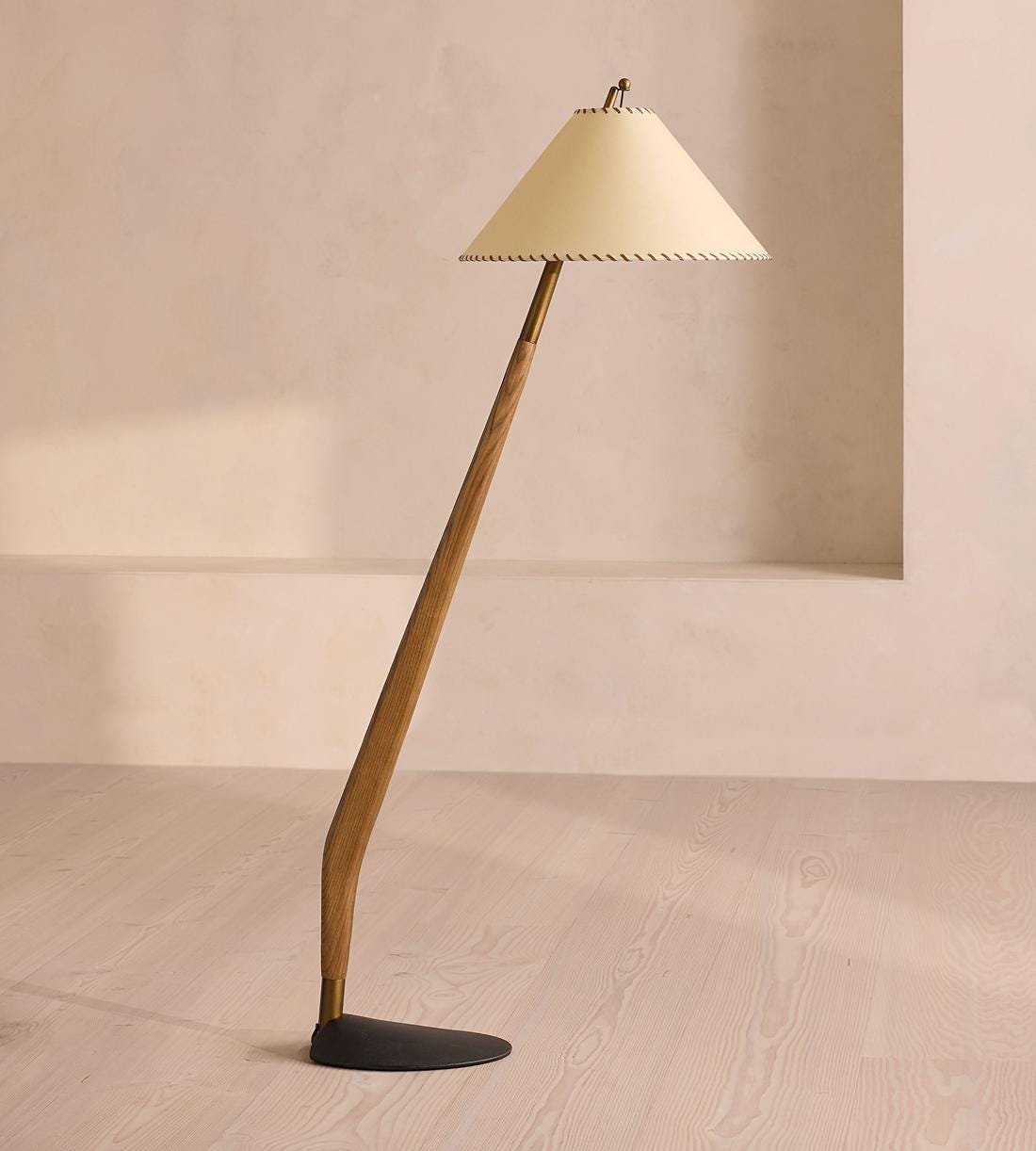 Freestanding floor lamp with wooden base and cream lampshade