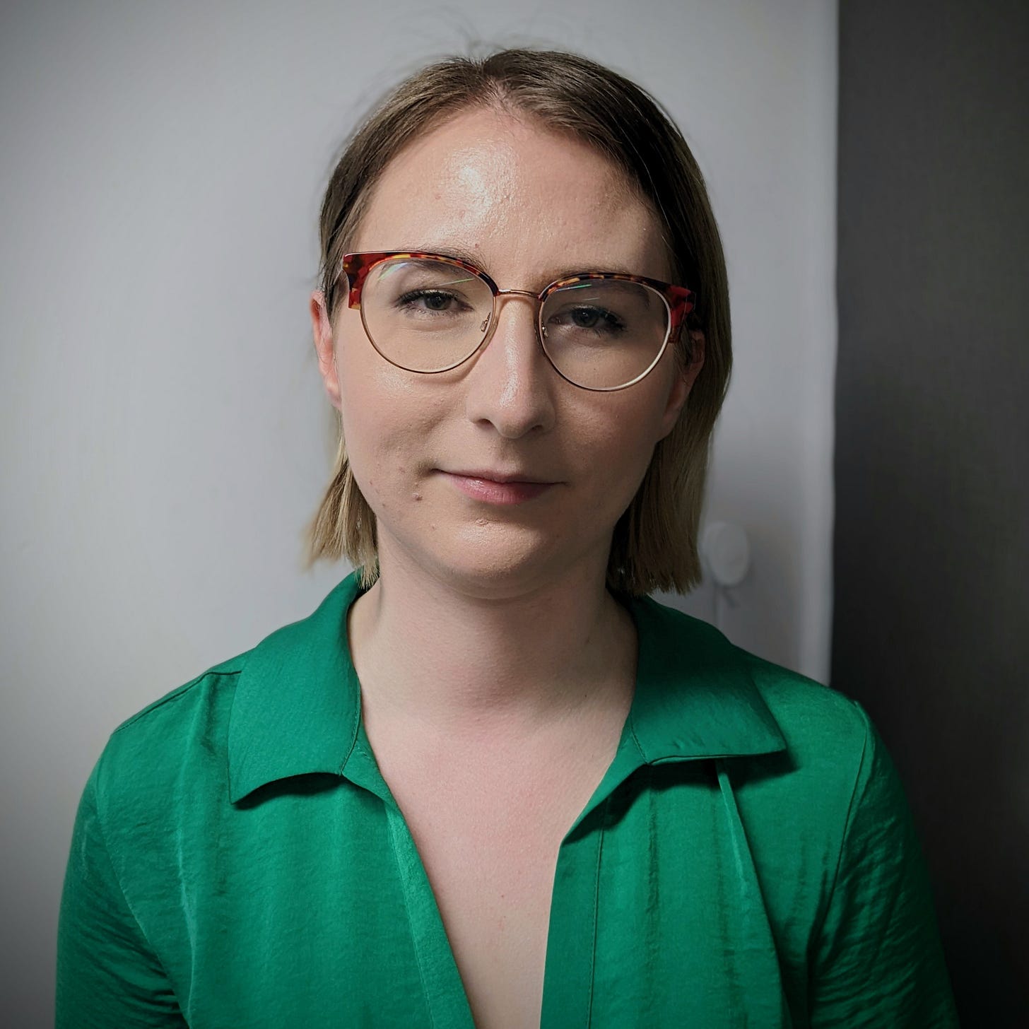 Anna-Ruth is a white woman wearing glasses and a green shirt