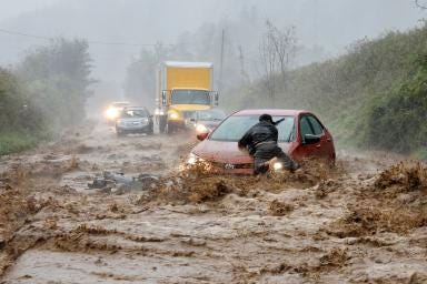 (1) A resident wades through a flooded street caused by heavy rains from typhoon Toraji in Ilagan City, Isabela province, northern Philippines, on Nov. 12.Noel Celis—AP. (2) A local resident helps free a car that became stranded in a stretch of flooding road as Tropical Storm Helene strikes, on the outskirts of Boone, N.C., on Sept. 27.Jonathan Drake—Reuters. (3) A woman looks out from her balcony at vehicles trapped in the street by flooding in Valencia, Spain, on Oct. 30.Alberto Saiz—AP. (4) An aircraft sits on the flooded tarmac of Salgado Filho International Airport in Porto Alegre, Brazil, on May 20. Anselmo Cunha—AFP/Getty Image. (5) Melting ice in West Antarctica, Feb. 10th. In 2024, the El Niño phenomenon intensified warmer ocean currents near West Antarctica, accelerating ice melt under the floating ice shelves. This warming is associated with a weakening of easterly winds that normally help keep warmer waters away from the Antarctic shelf. With weaker winds, more Circumpolar Deep Water—naturally warmer, deeper ocean water—reached the ice shelves, where it melted ice from below, increasing sea-level rise risks globally.Jasper Doest. (6) In August, a large fire front advances over the Pantanal, the largest tropical wetland on the planet. The South American region, located largely in southwestern Brazil, has been facing a historic drought due to human actions and climate change. Lalo de Almeida—Panos Pictures.