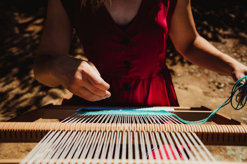 Emily Wick weaving a tapestry.
