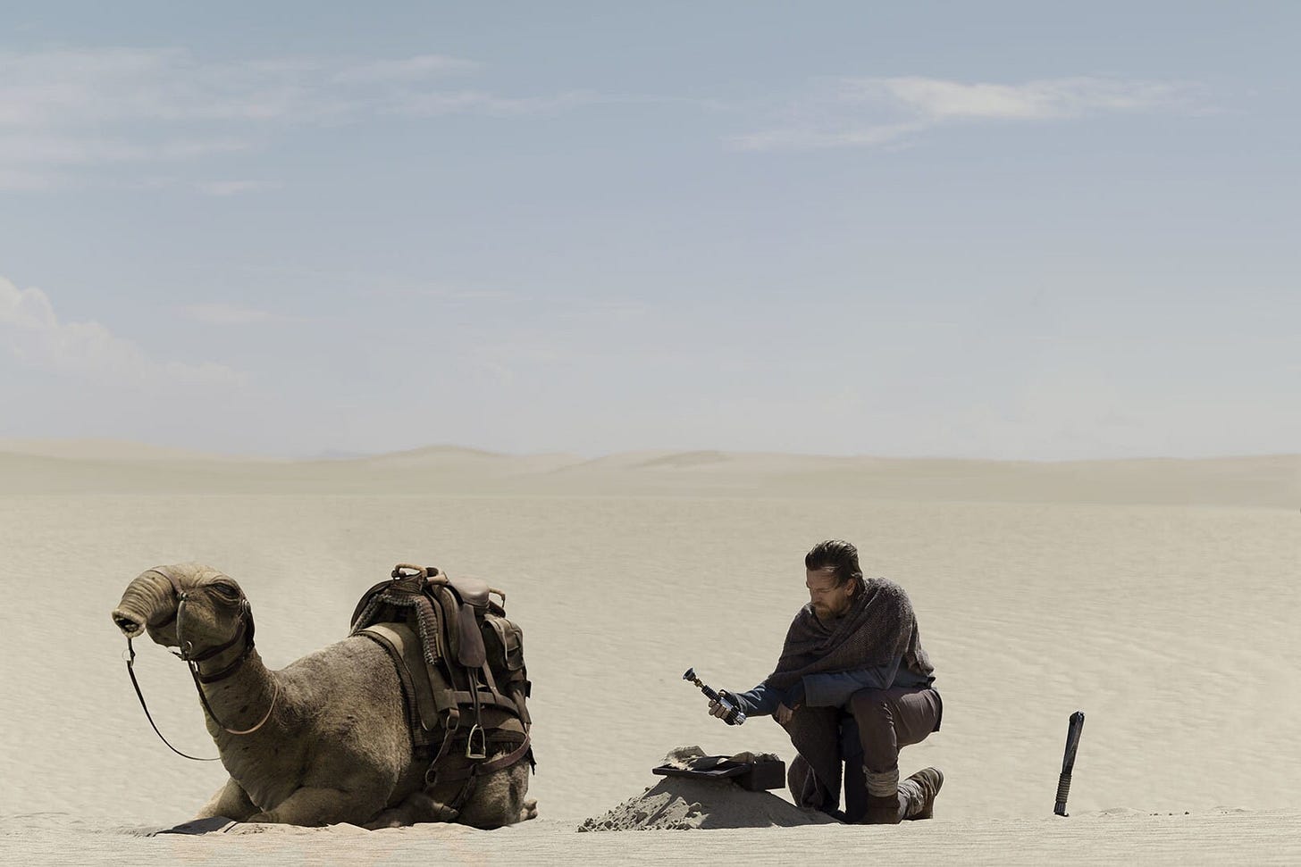 Ben Kenobi burying his lightsaber 