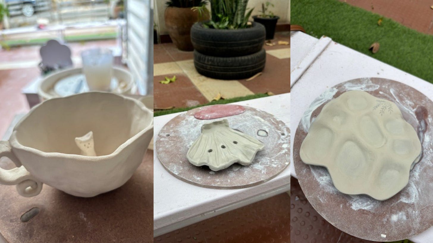 a white ceramic mug, a shell soap dish, a pallette with a leaf pattern