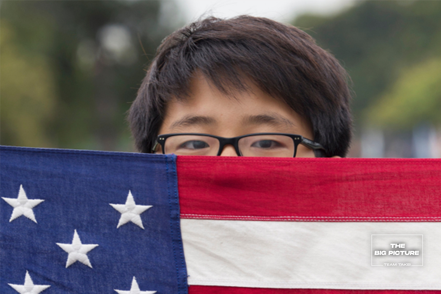 Asian American Boy Scout holds United States flag Asian American Boy Scout holds United States flag