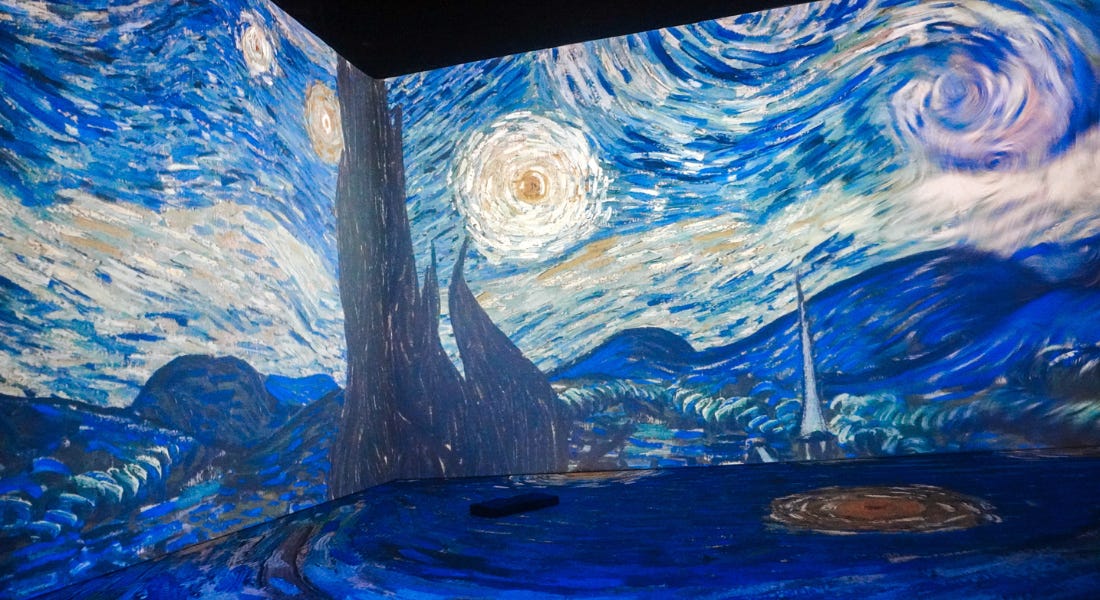 A wall with Van Gogh's The Starry Night projected onto it and the floor A wall with Van Gogh's The Starry Night projected onto it and the floor