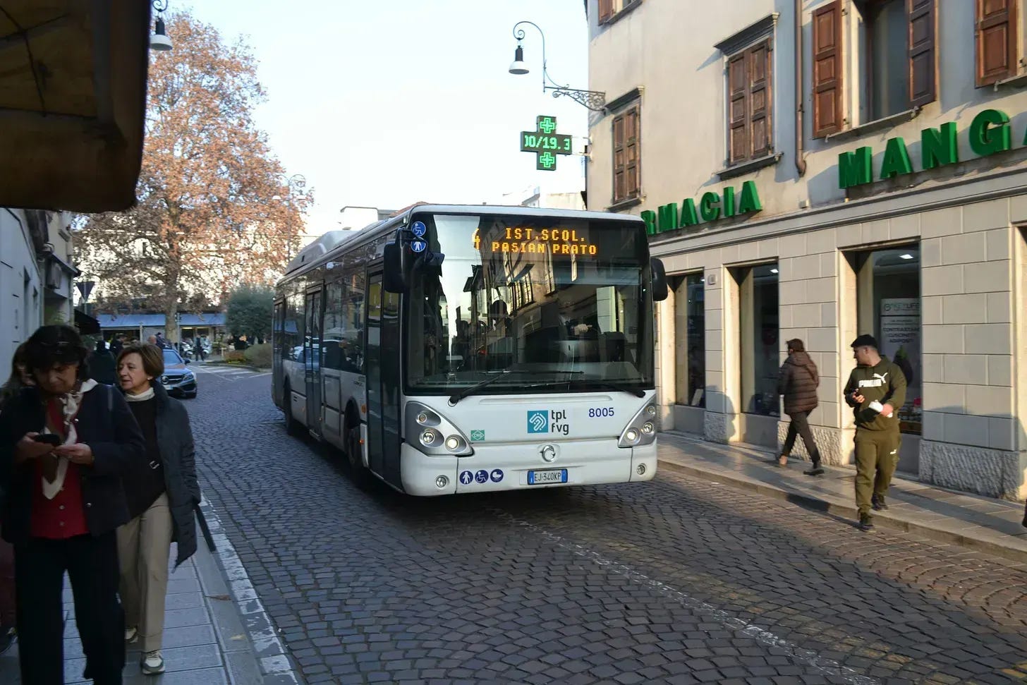 Bus in front of an Italian pharmacy