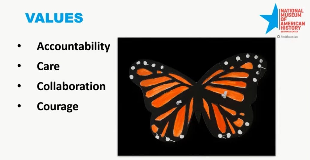 Screenshot of a PowerPoint slide from a presentation by the Museum of American History. The slide's heading is 'Values,' with bullet-point headings 'Accountability, Care, Collaboration, and Courage.' The slide is illustrated with an item of folk art, a depiction of a monarch butterfly, which the White House report claims is offensive because monarch butterflies are 'a well-known symbol in the illegal alien activist community, symbolizing illegal aliens crossing the border from Mexico into the U.S.' Screenshot of a PowerPoint slide from a presentation by the Museum of American History. The slide's heading is 'Values,' with bullet-point headings 'Accountability, Care, Collaboration, and Courage.' The slide is illustrated with an item of folk art, a depiction of a monarch butterfly, which the White House report claims is offensive because monarch butterflies are 'a well-known symbol in the illegal alien activist community, symbolizing illegal aliens crossing the border from Mexico into the U.S.'