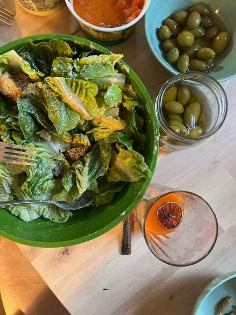 three pictures of food, one of a big green salad, one of grilled corn and cheese, and one of a mac and cheese