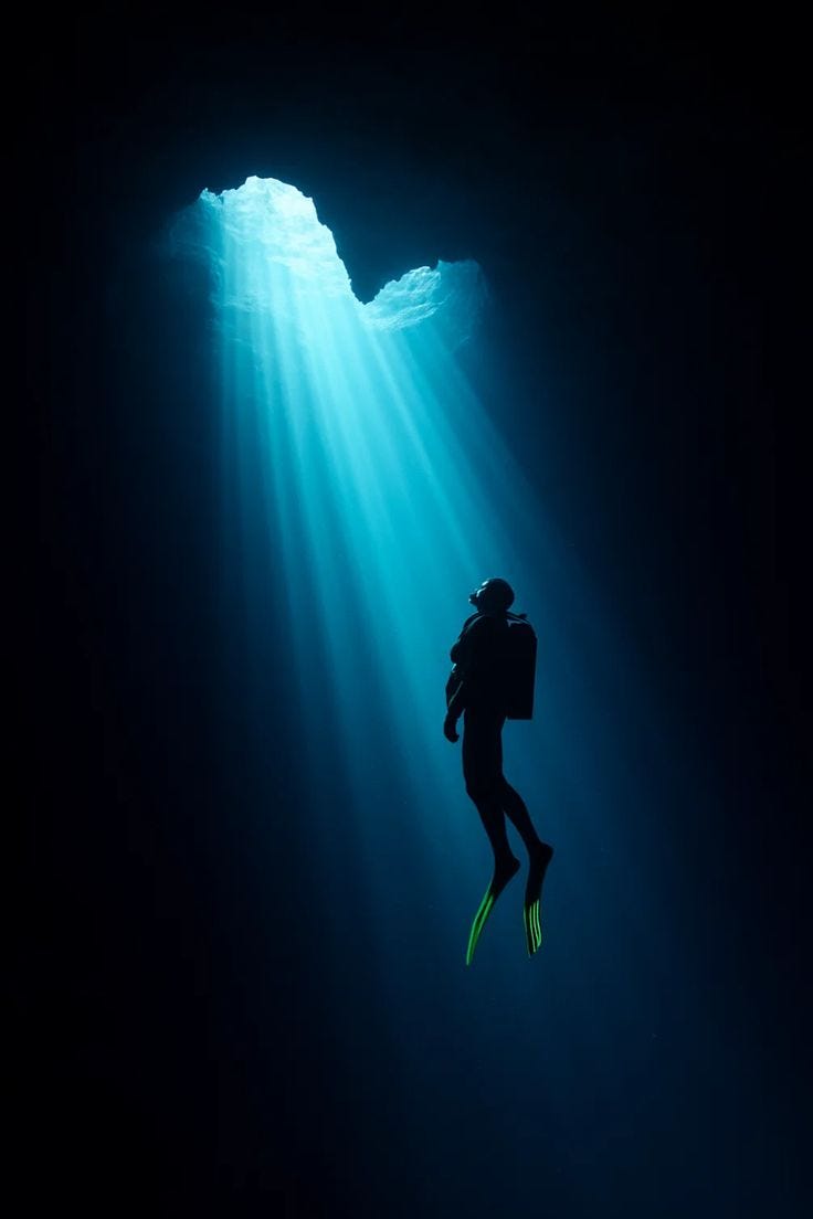 This may contain: a scuba diver is silhouetted against the sun's rays as he swims through the water This may contain: a scuba diver is silhouetted against the sun's rays as he swims through the water
