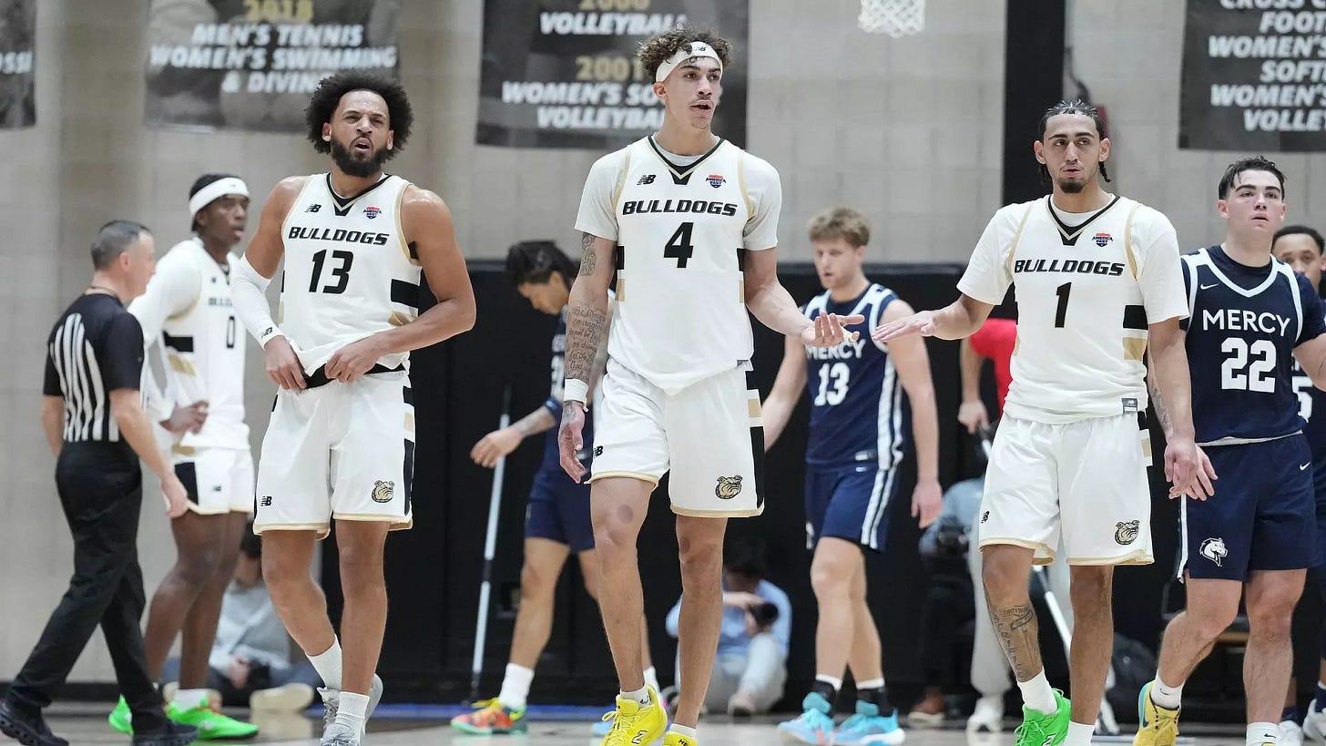 Three Bryant Players walking up the court