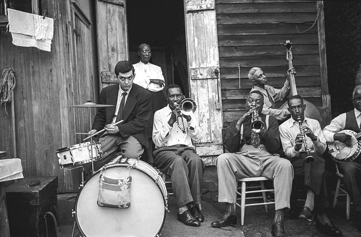 May be a black-and-white image of 7 people, accordion, saxophone and clarinet