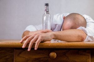 man slumped over a bar top