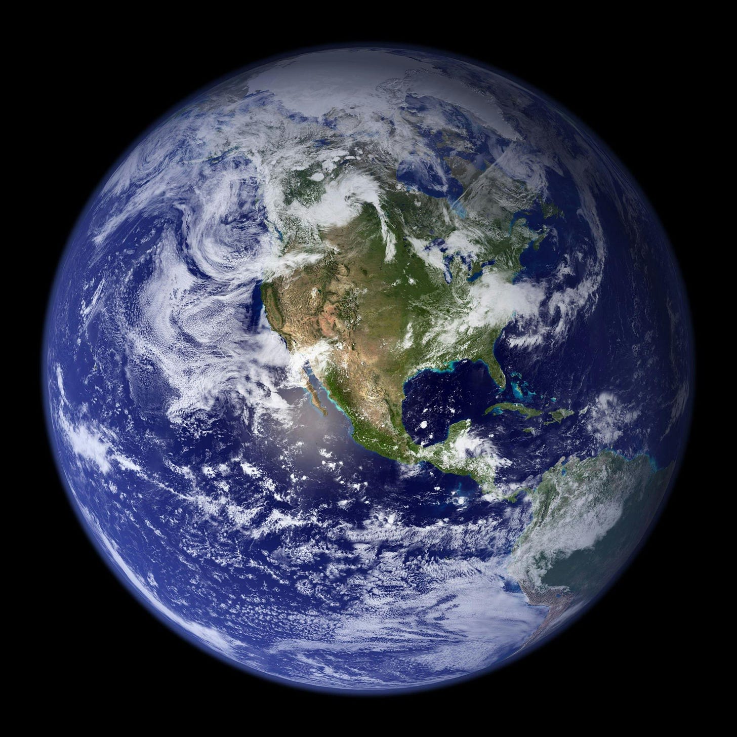 A photo of the Earth as seen from space, showing the continent of North America in the foreground on the blue planet, surrounded by swirling white clouds. A photo of the Earth as seen from space, showing the continent of North America in the foreground on the blue planet, surrounded by swirling white clouds.