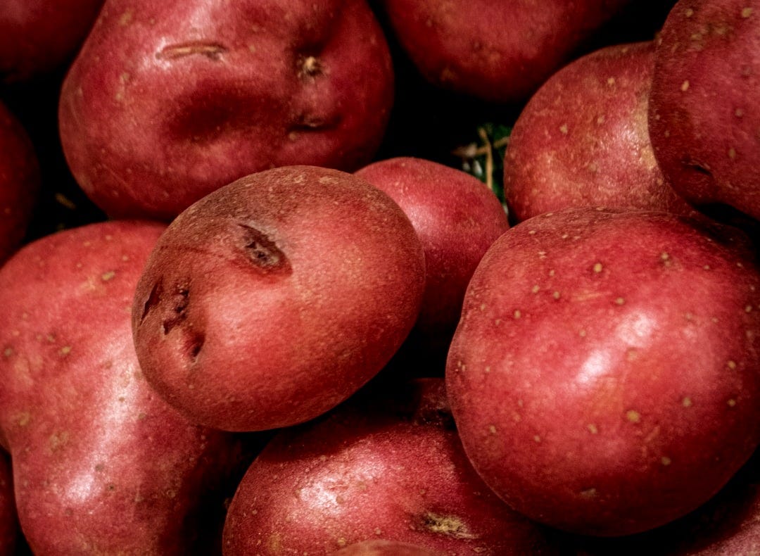A pile of fresh red potatoes.