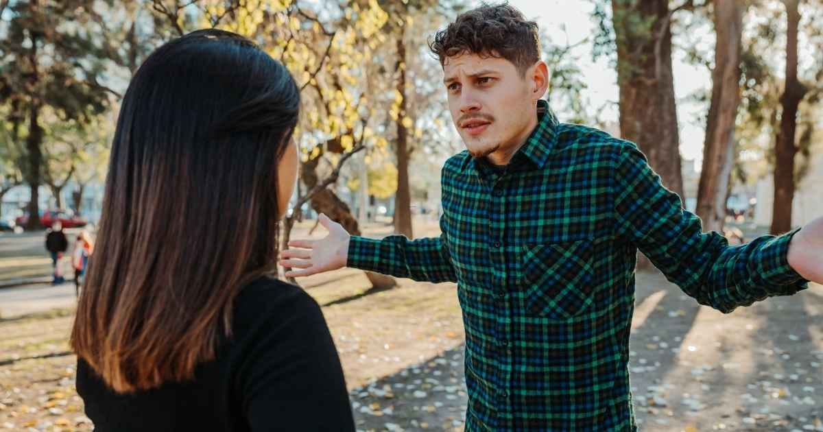 a young couple arguing outdoors