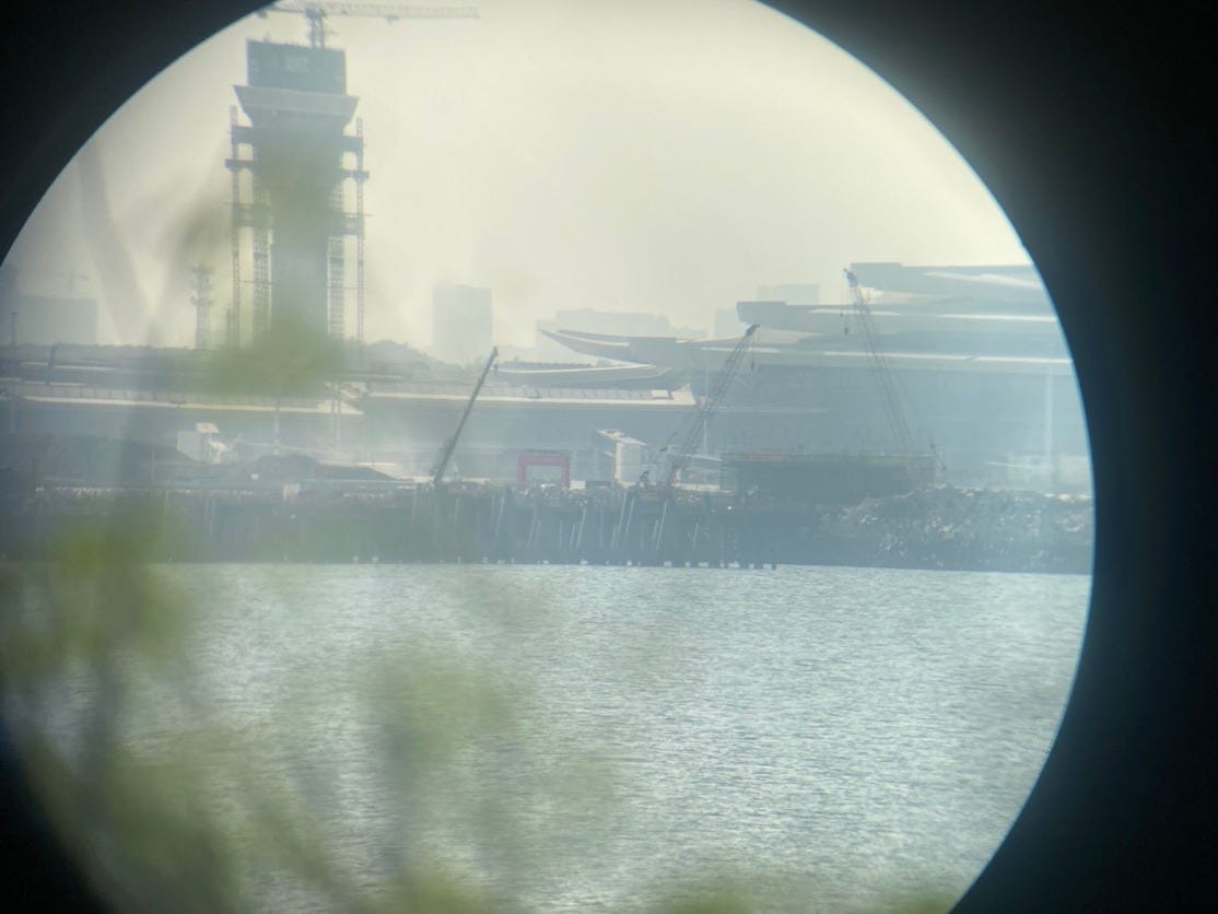 A view through a circular window of a city

AI-generated content may be incorrect.