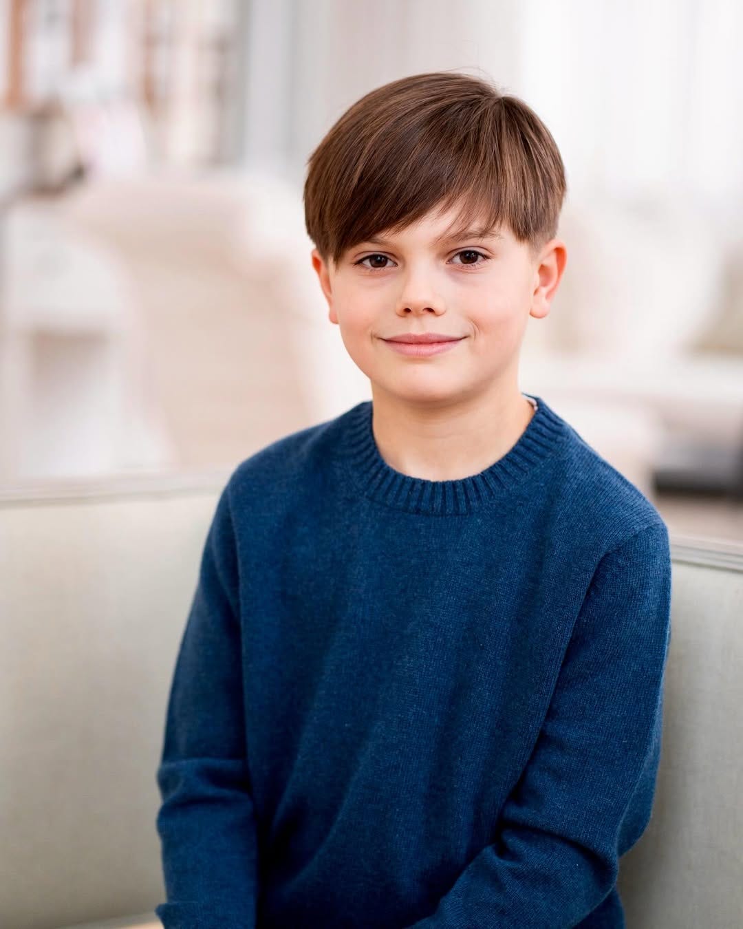 Prince Oscar is smiling while wearing a navy jumper. Prince Oscar is smiling while wearing a navy jumper.