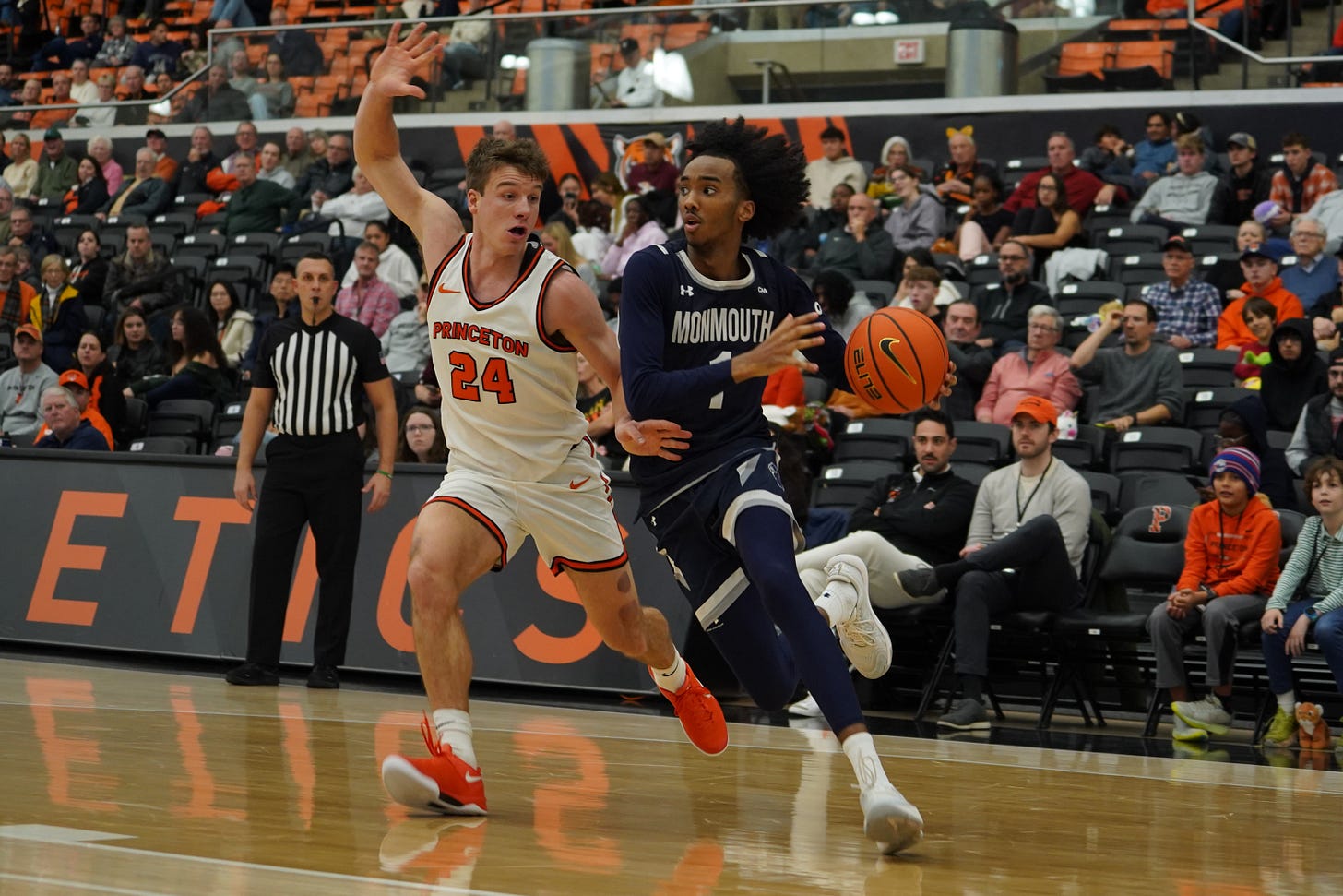 Abdi Bashir Jr. of Monmouth drives with the ball against Princeton’s Blake Peters on Dec. 10, 2024. (Photo courtesy of Monmouth Athletics)