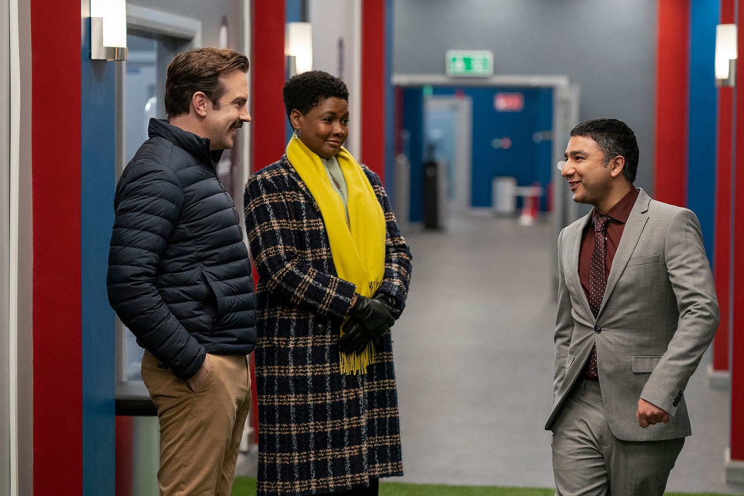 A group of people standing in a hallway

Description automatically generated