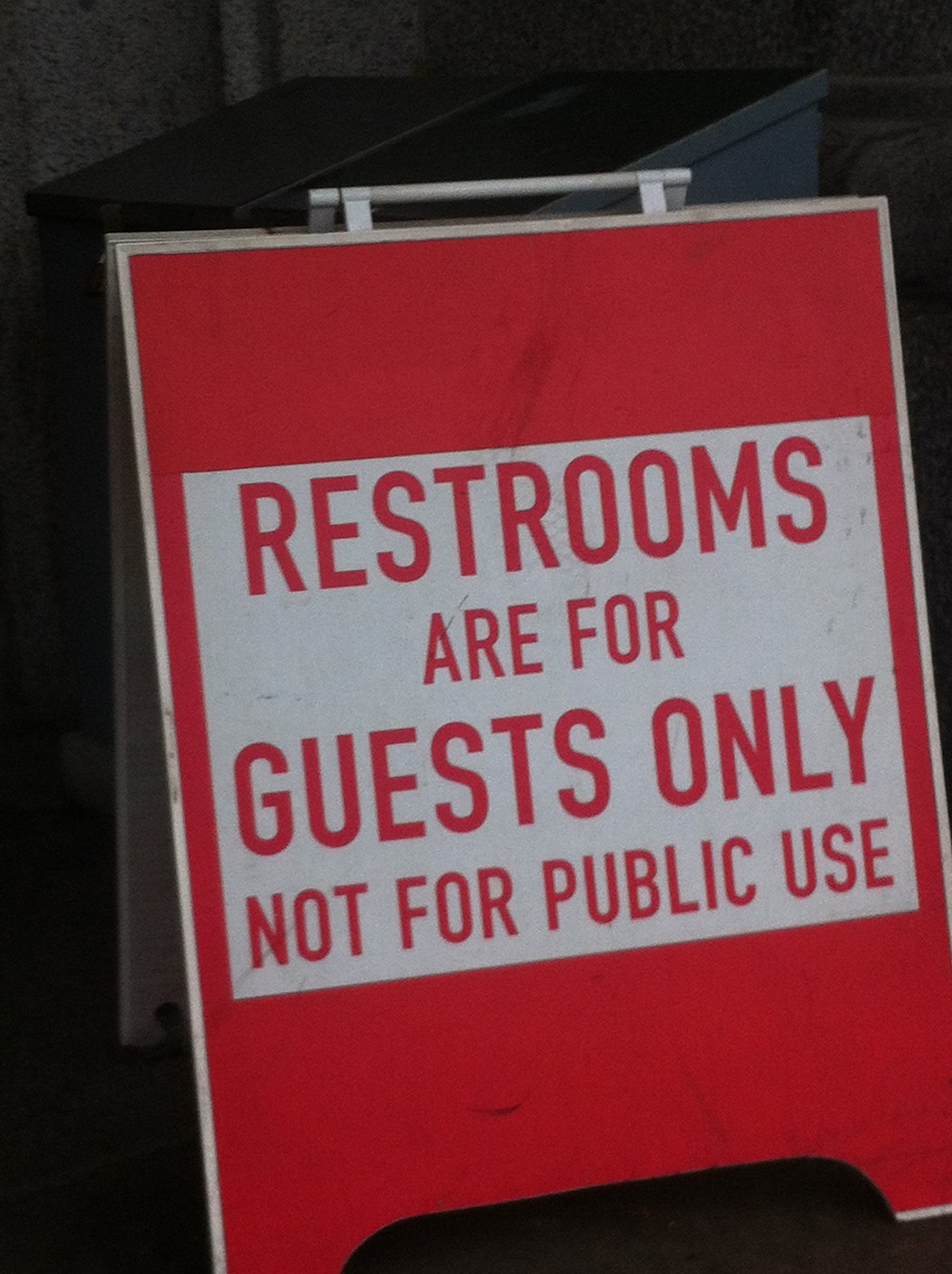 Sandwich board that says: restrooms are for guests only. not for public use
