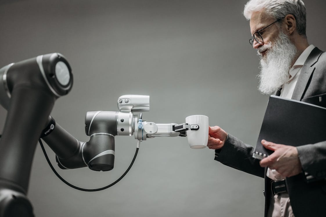 Free A Robot Holding a Cup Stock Photo Free A Robot Holding a Cup Stock Photo