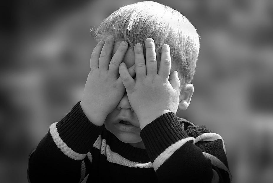 The face of child. He is hiding behind his hands. Still your child The face of child. He is hiding behind his hands. Still your child
