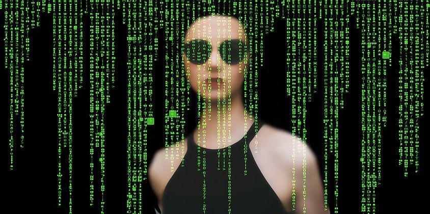 woman with sunglasses behind matrix code