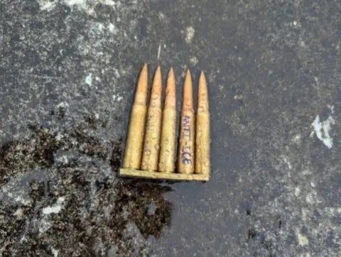 A group of bullets in a wooden box

AI-generated content may be incorrect.