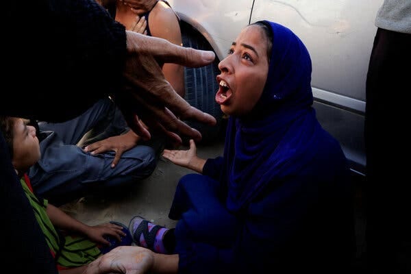 A woman screams with her palms up.