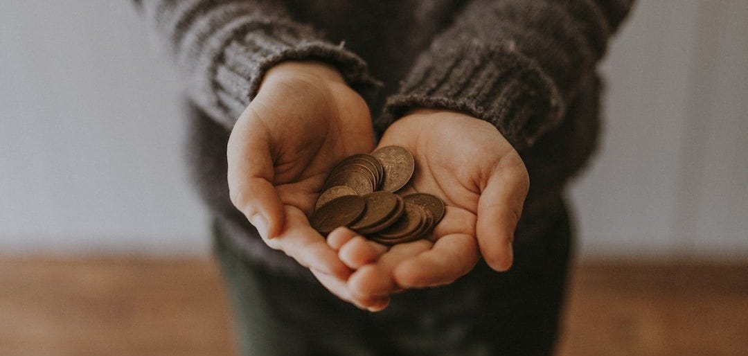 copper-colored coins on in person's hands