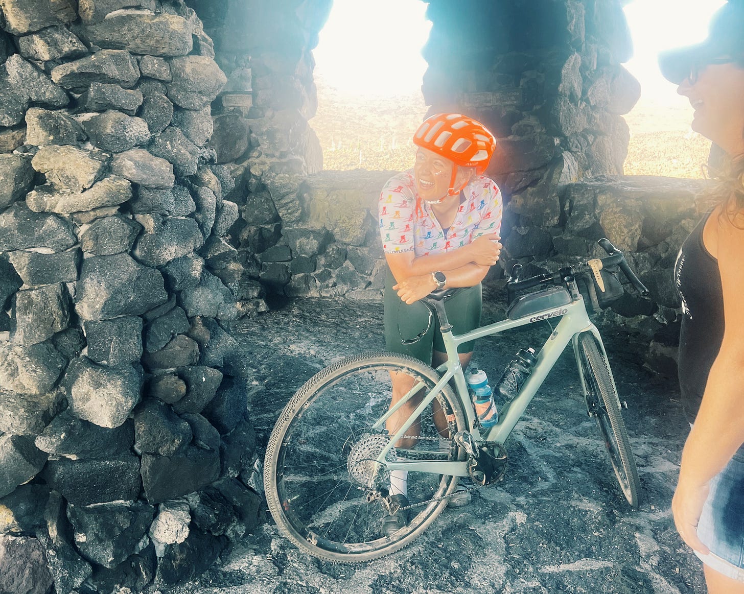 One gal on a bike, looking exhausted, with random woman-soon-to-be-savior standing to the right.