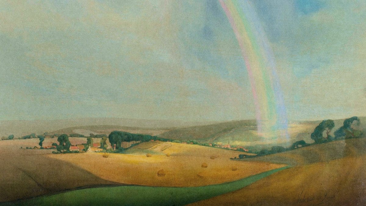 A rainbow, often seen as a symbol of luck, arcs over a sunlit rural landscape with rolling hills, scattered trees, and hay bales under a partly cloudy sky.