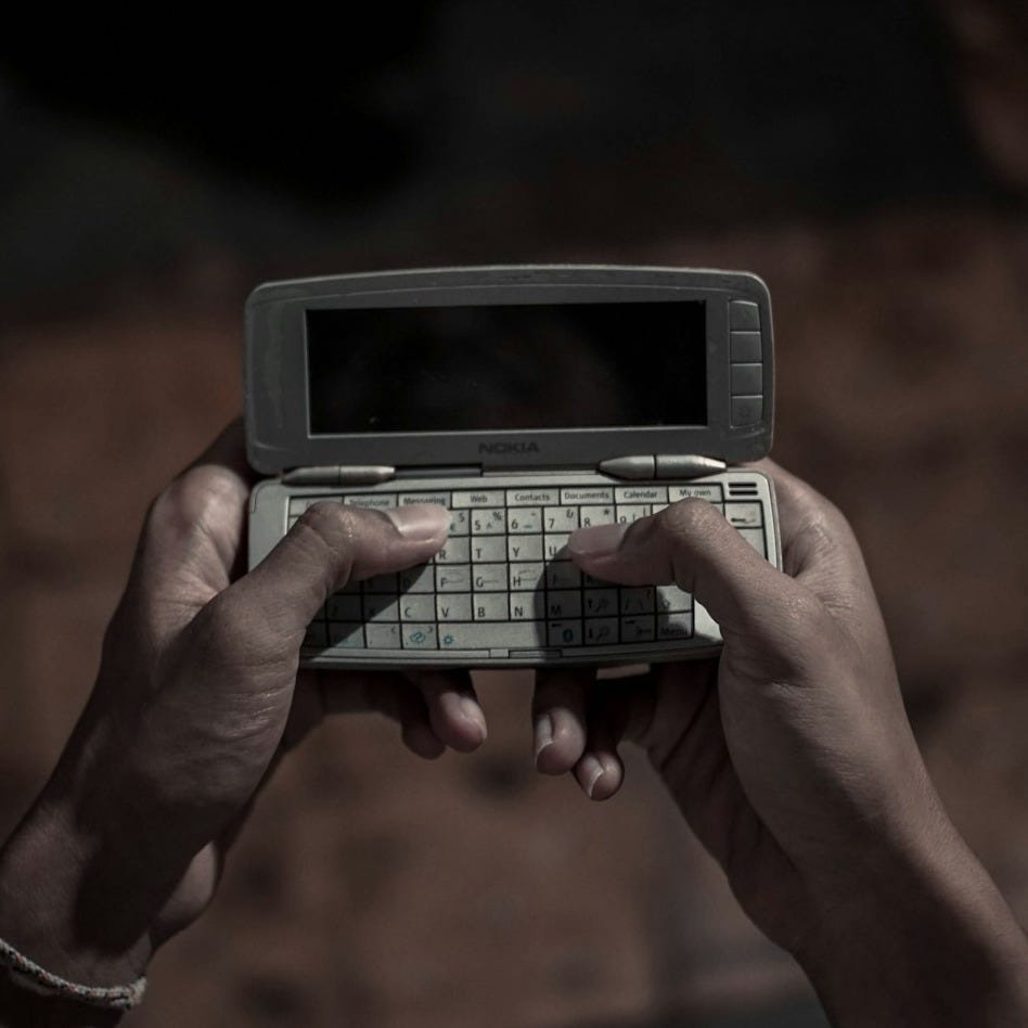 person holding silver electronic diary