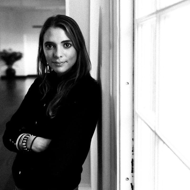 Photo of Kelly Gordon in black and white standing against a wall