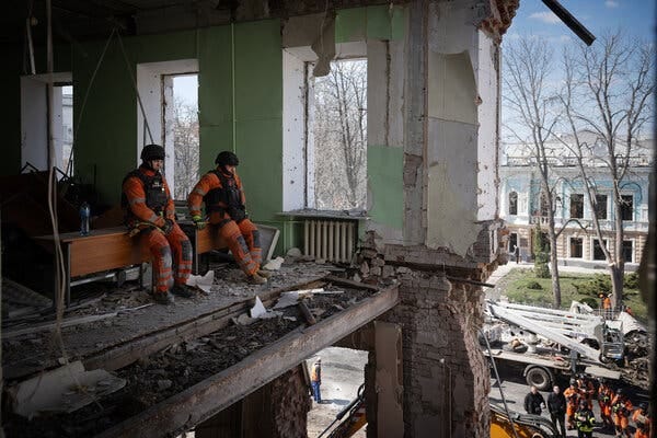 Workers in orange uniforms in a destroyed building. Workers in orange uniforms in a destroyed building.