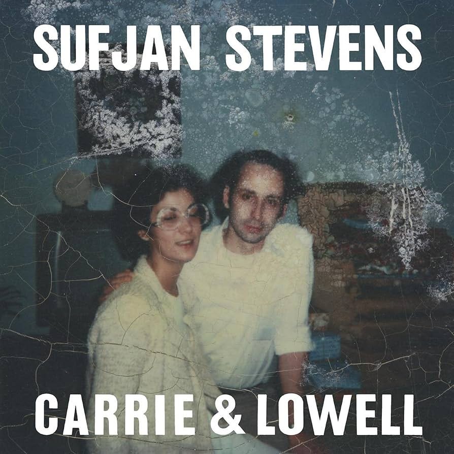 The album cover for Sufjan Stevens' Carrie & Lowell. It shows an old, damaged photo of Carrie, Sufjan's mother, wearing oversized horn-rimmed glasses, and Sufjan's stepfather Lowell, both in their late 20s or early 30s. 