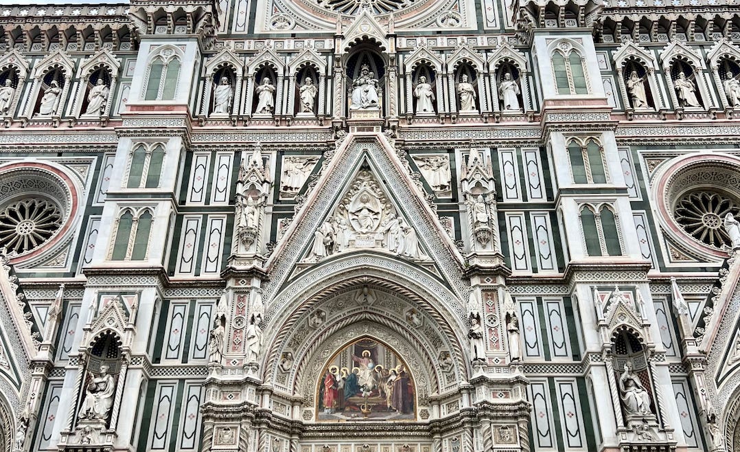 Image of Santa Maria del Fiore, the cathedral in Florence, Italy, which is comprised of colorful marble, many statues, and swathes of intricate art. Image of Santa Maria del Fiore, the cathedral in Florence, Italy, which is comprised of colorful marble, many statues, and swathes of intricate art.