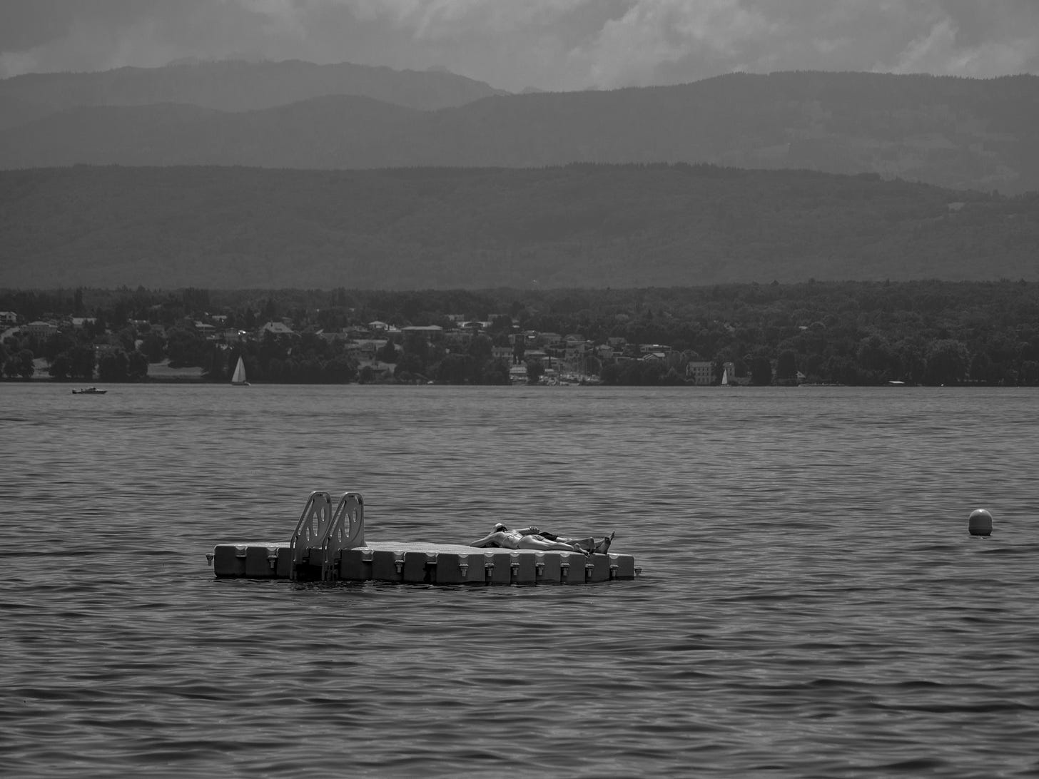 Black and White photo of a lake with a floating pontoon