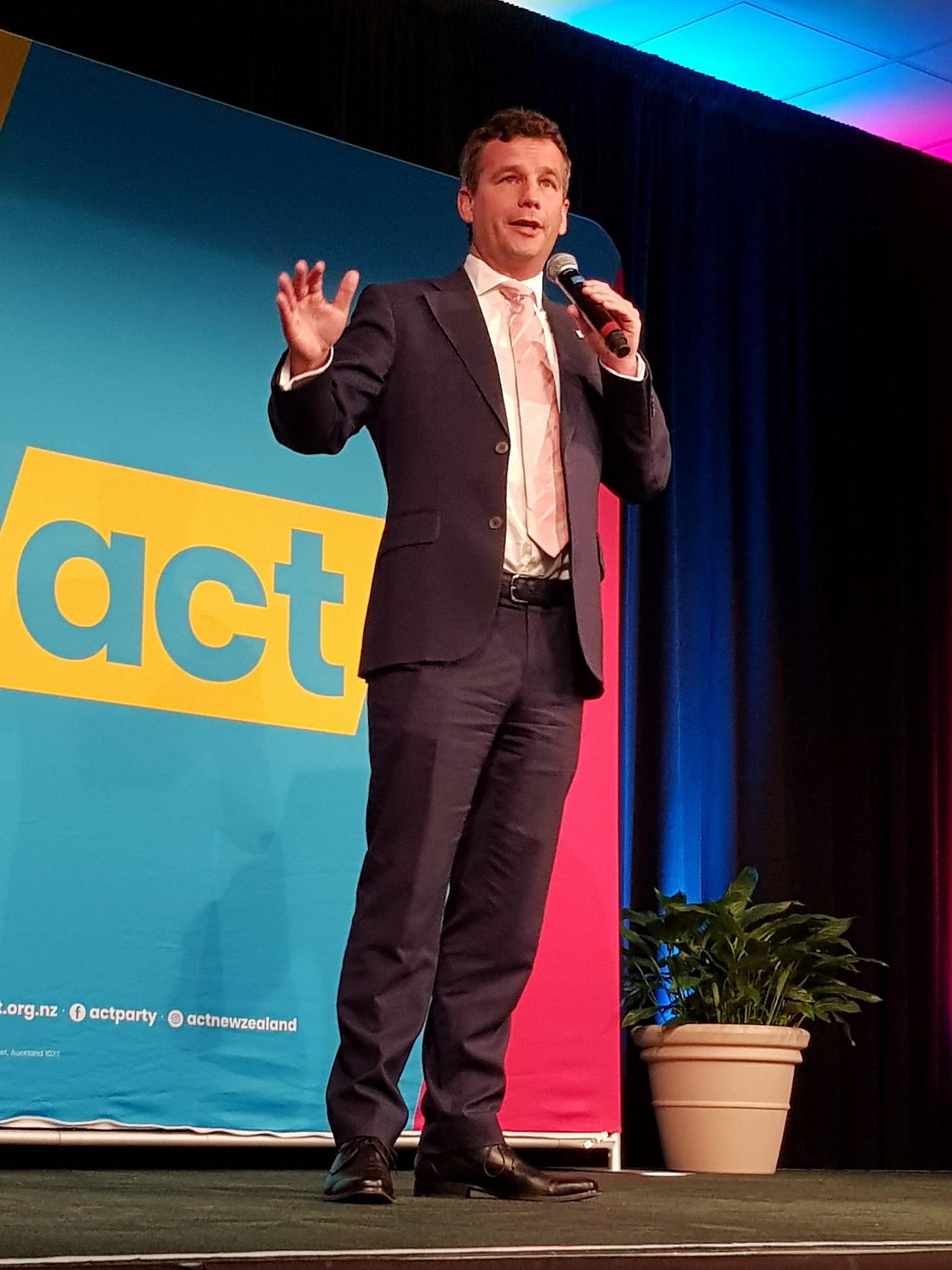 David Seymour on stage infront of an ACT Party banner David Seymour on stage infront of an ACT Party banner