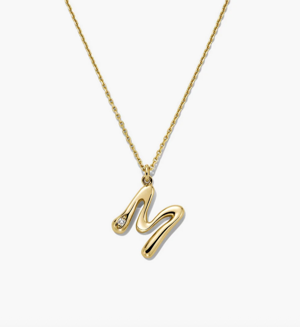 Gold necklace with bubble 'M' pendant.
