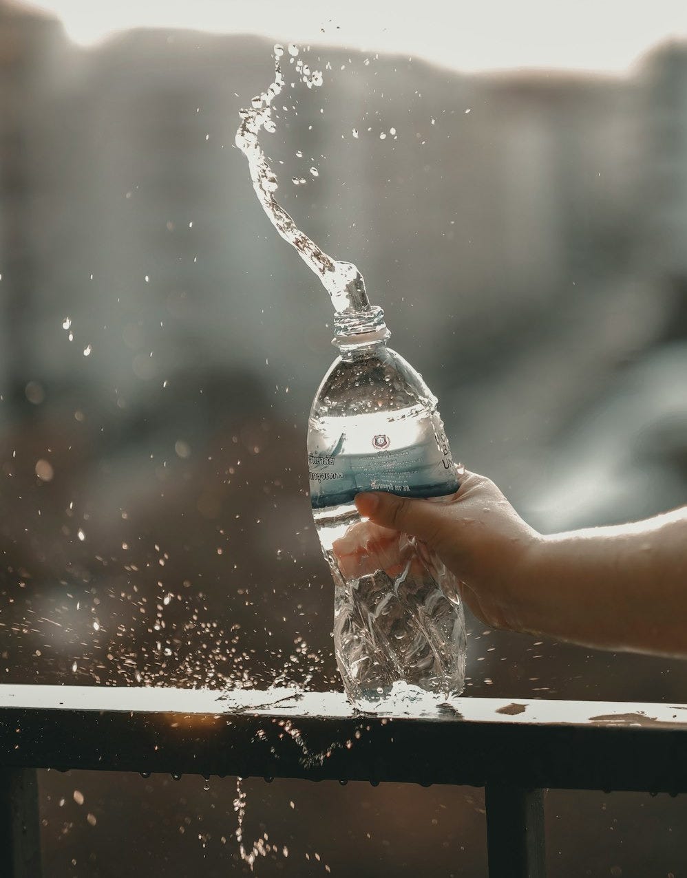 white and blue labeled disposable bottled water