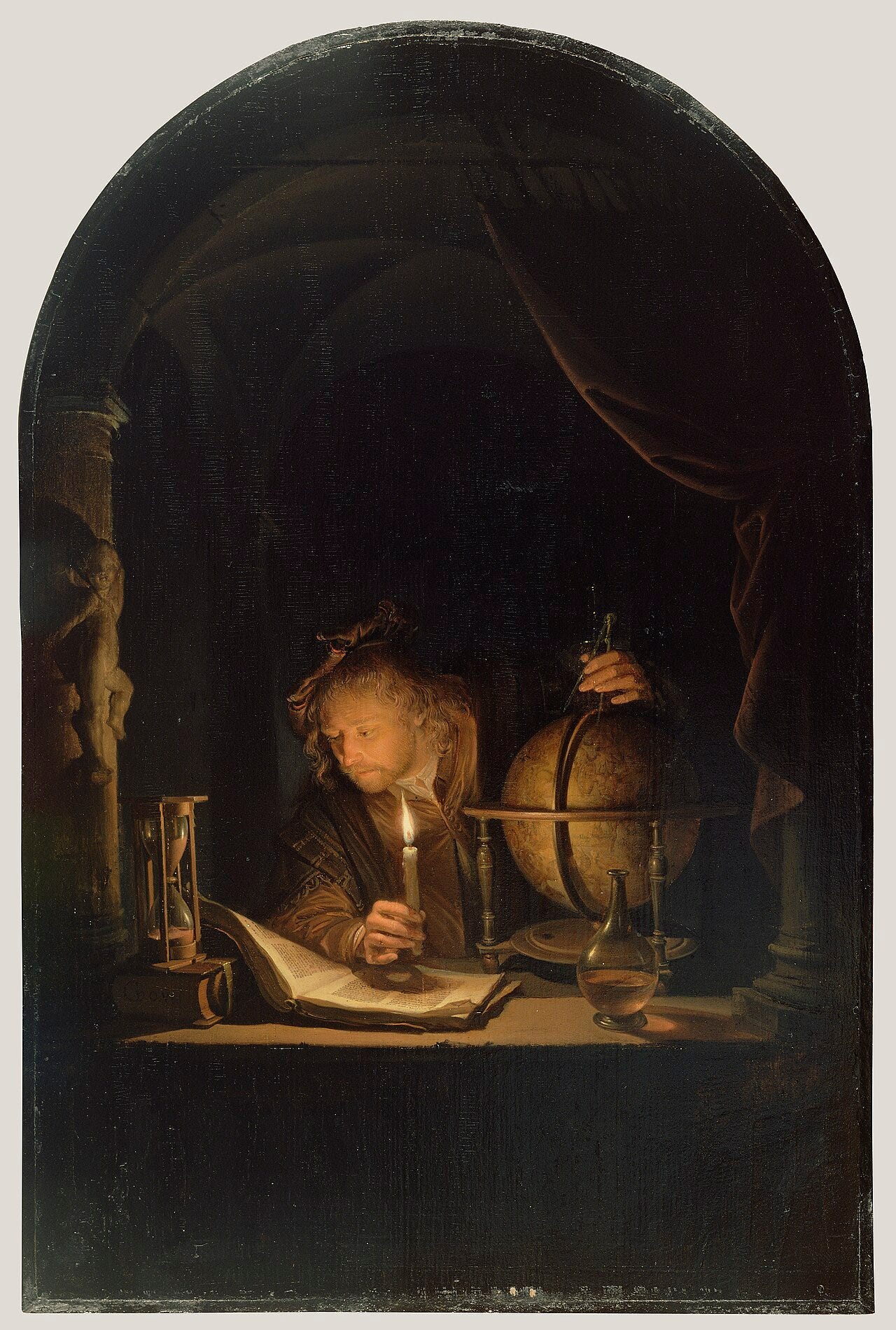 An astronomer with a candle at a celestial globe at night An astronomer with a candle at a celestial globe at night