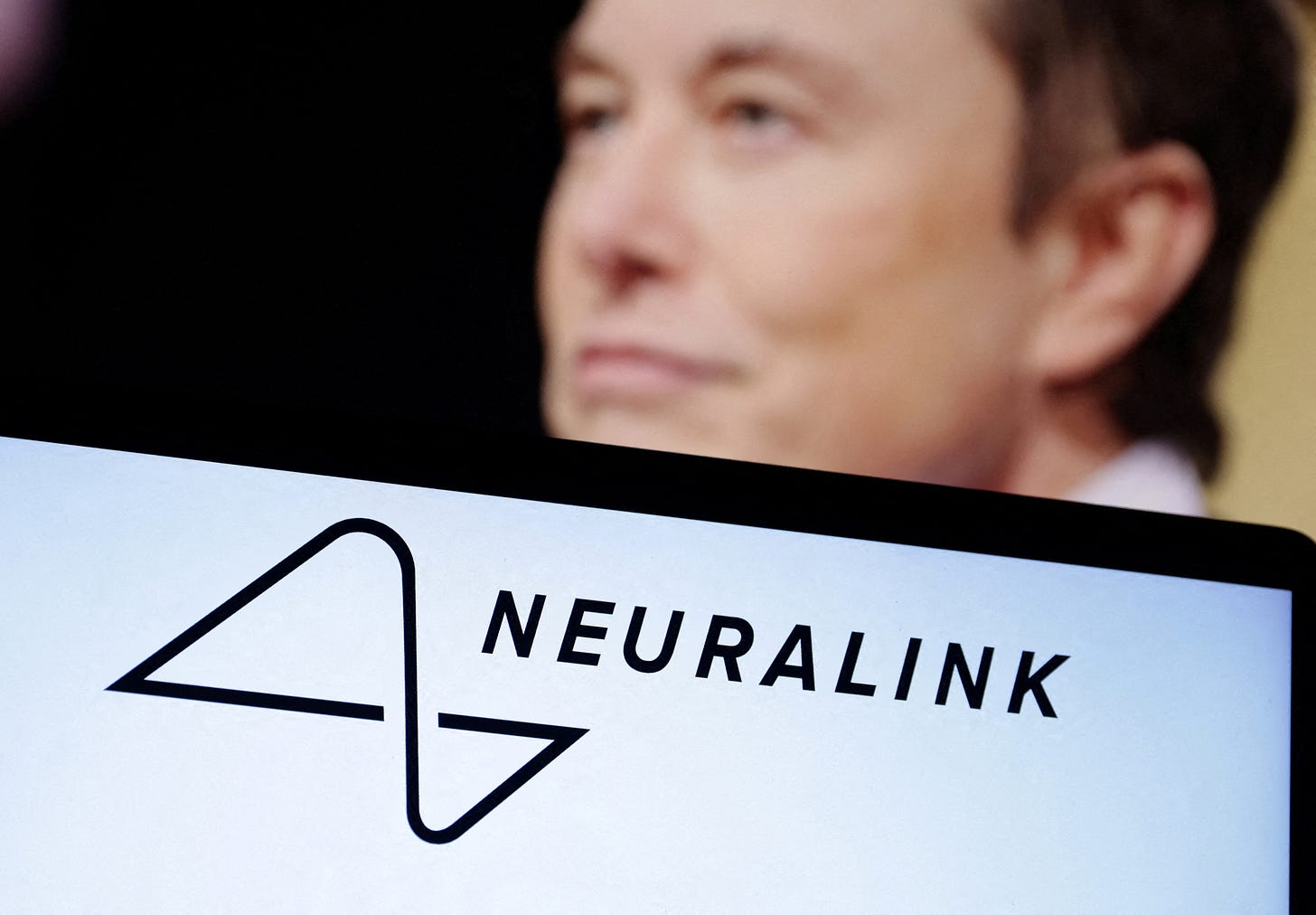 Illustration shows Neuralink logo and Elon Musk photo Illustration shows Neuralink logo and Elon Musk photo