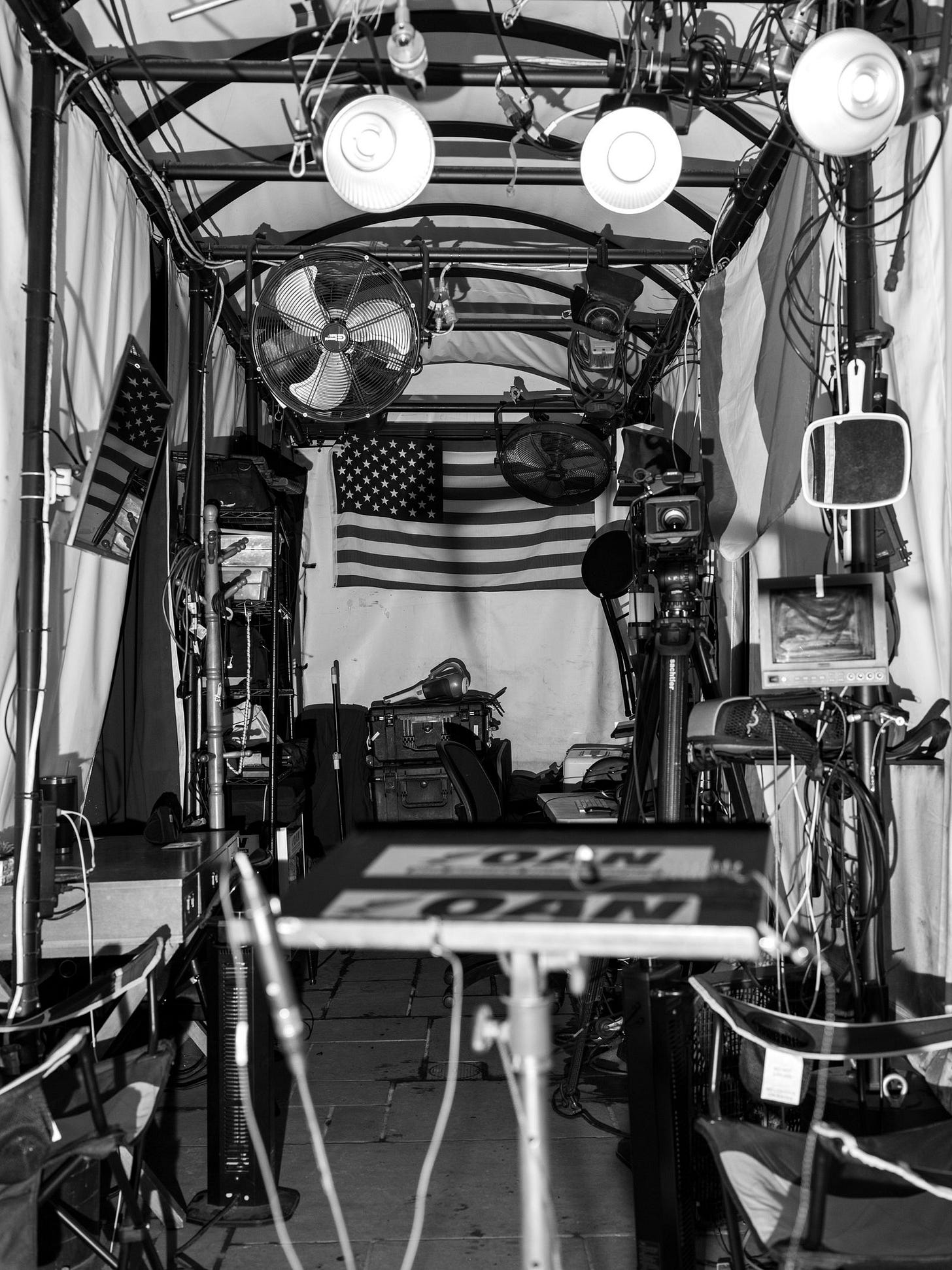 Flags and camera equipment are seen in a media tent near the White House. Flags and camera equipment are seen in a media tent near the White House.