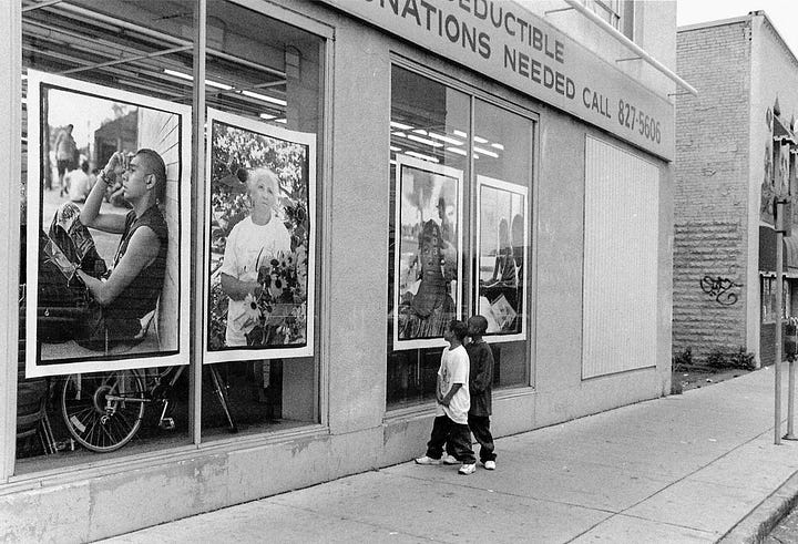 Two photographs. One is of two boys looking at large format photos posted in a store window on Lake Street. The second is a photo from the exhibit. It shows a small boy walking down the street holding a balloon and his tee shirt.