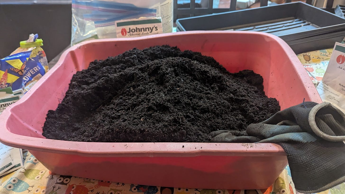 A red plastic rectangular bin filled with potting soil A red plastic rectangular bin filled with potting soil