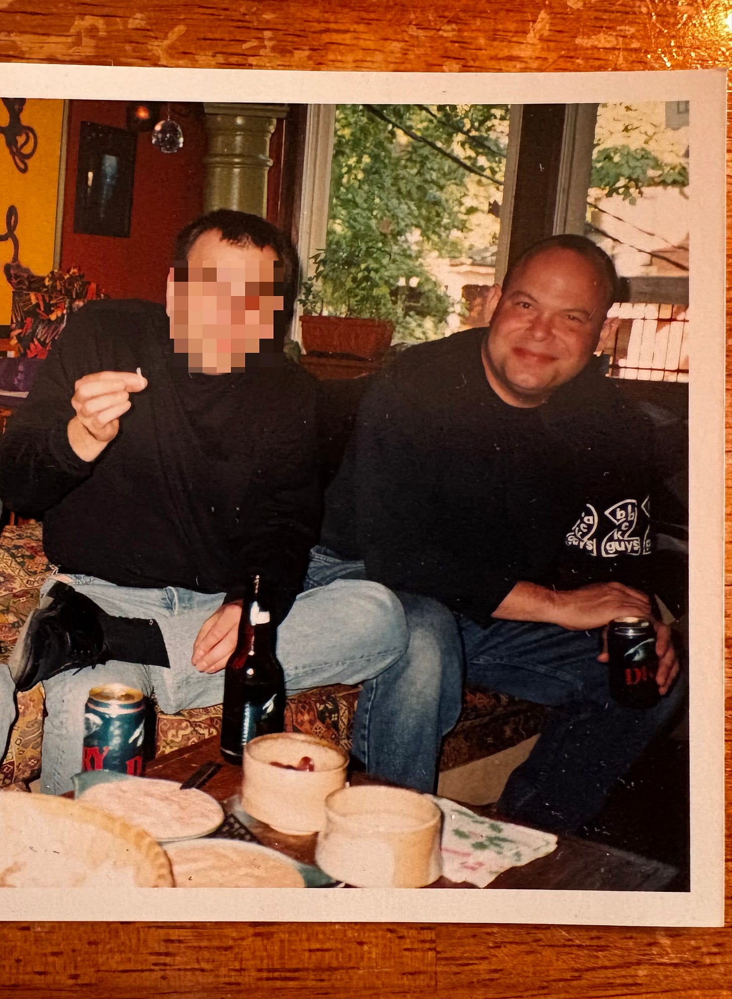 Pictured: Kirby & undisclosed friend seated in a living room passing a joint and drinking Molson Dry