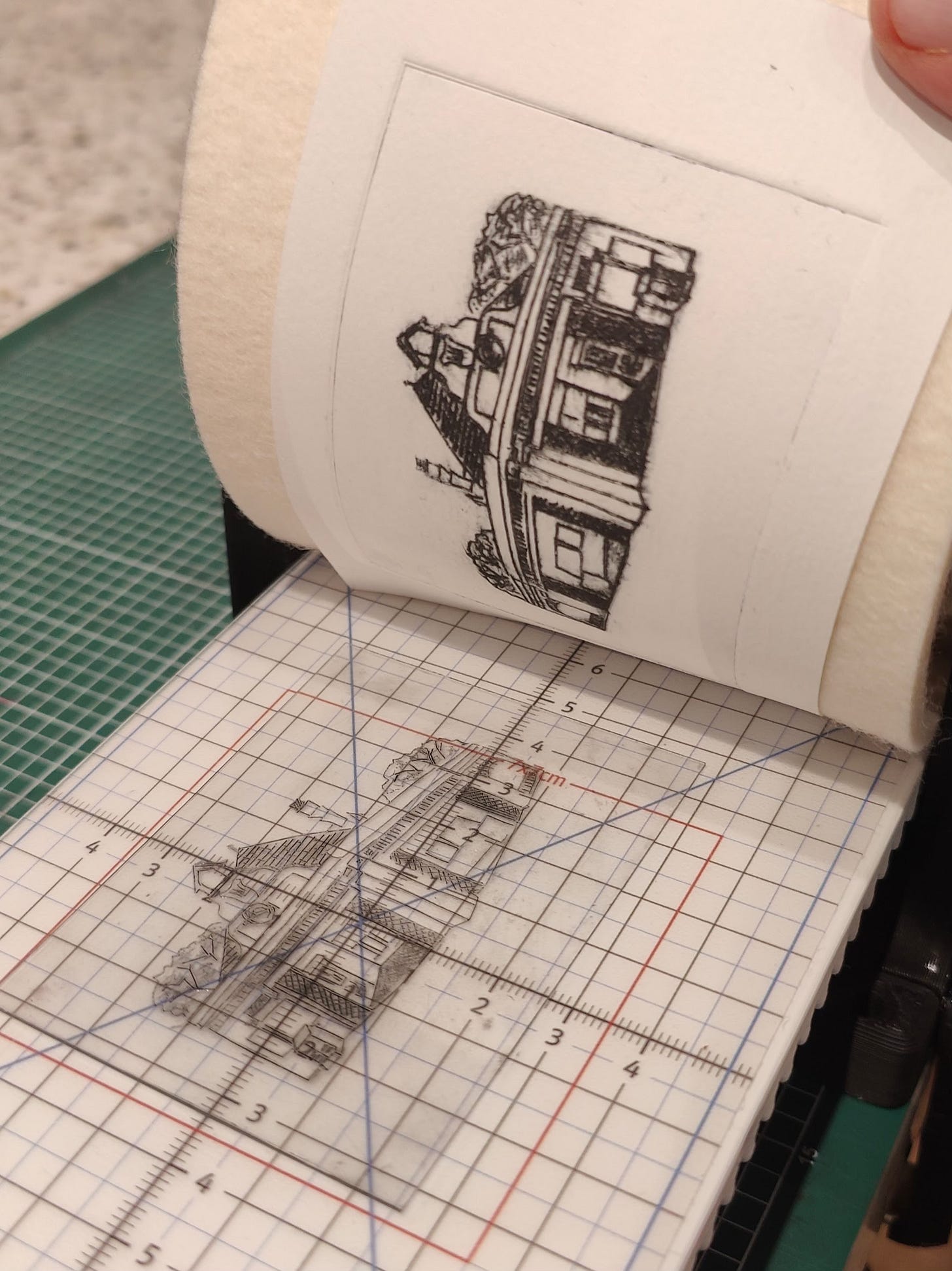 Print press with small perspex drypoint etch of a tube station.