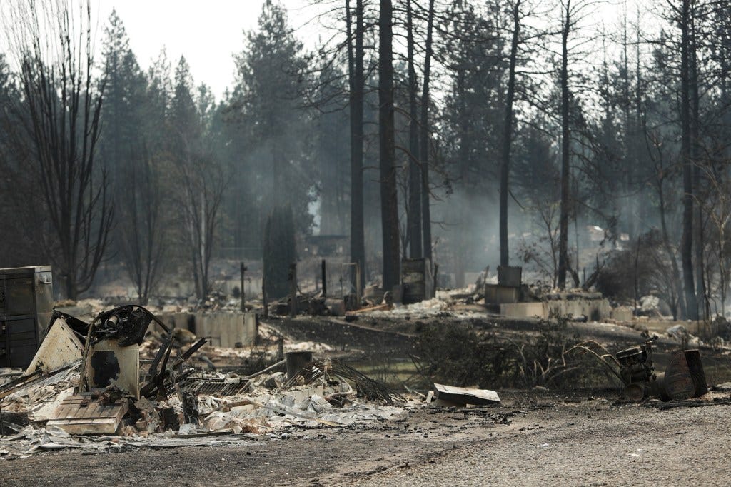 Smoke rises from burnt structures after a wildfire in a residential area of Westgate, Monday, Aug. 3, 2026, in Spokane, Wash. Smoke rises from burnt structures after a wildfire in a residential area of Westgate, Monday, Aug. 3, 2026, in Spokane, Wash.
