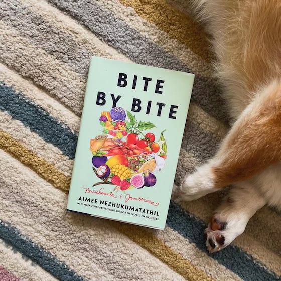 a photo of the book Bite by Bite. Dylan’s little arms can be seen on the right side.