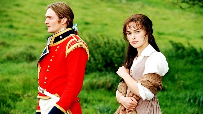 Elizabeth Bennet stands next to George Wickham in a field but is looking away from him, off into the distance. 